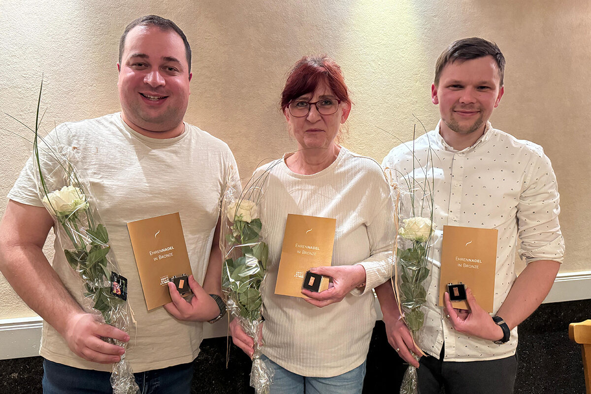Ehrung Bronze Landessportbund 2025 Drei Personen mit Blumen, Urkunden und Ehrennadel in Bronze bei einer Ehrung.